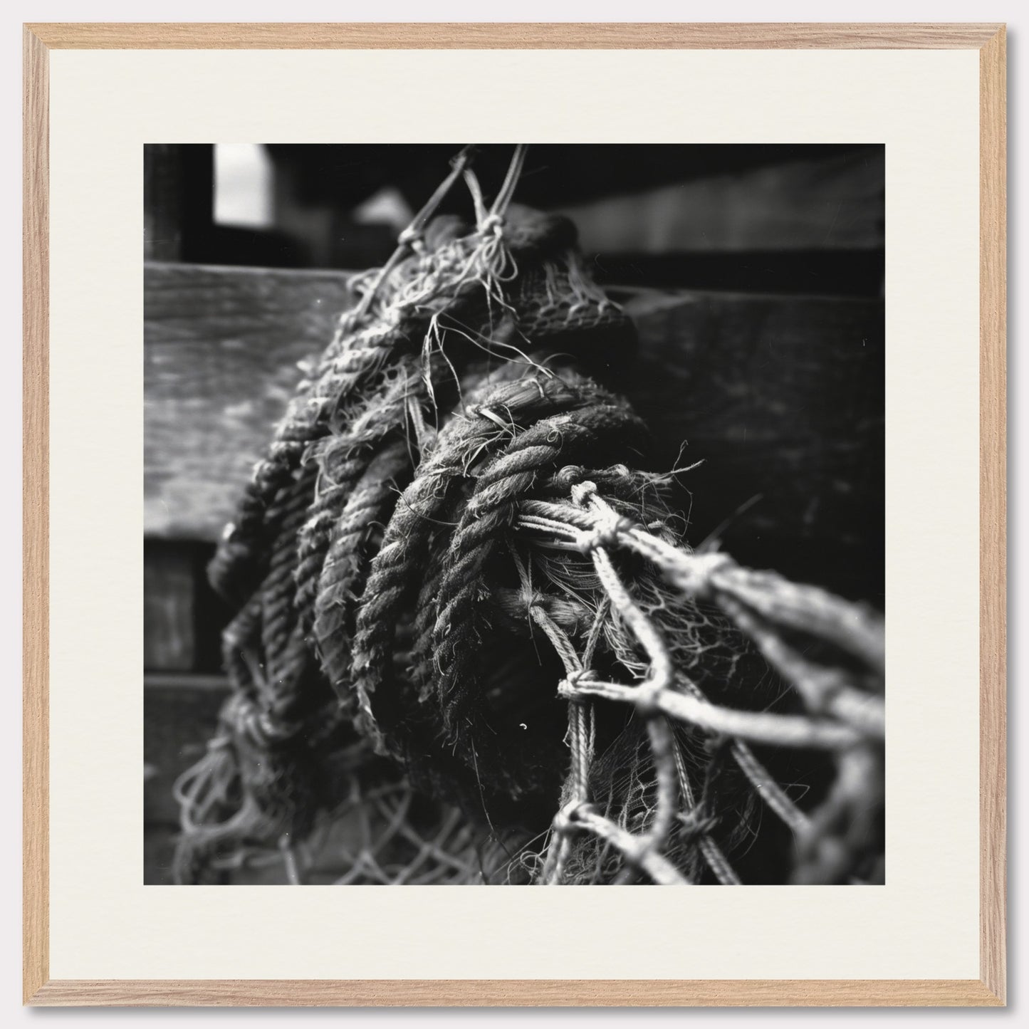 This is a black and white illustration of coiled ropes and fishing nets. The image captures the textures and details of the ropes and nets, emphasizing their rough and worn appearance.