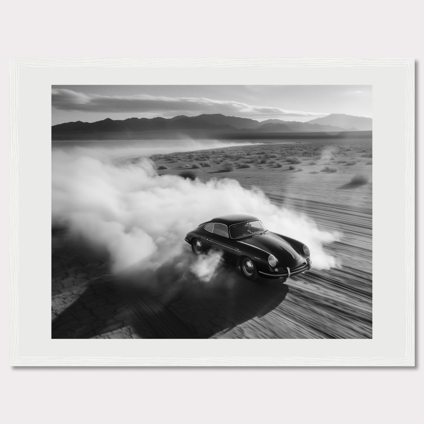 This striking black and white photograph captures a classic car speeding through a desert landscape, leaving a trail of dust in its wake. The image exudes a sense of freedom and adventure, with the distant mountains adding to the dramatic scenery.