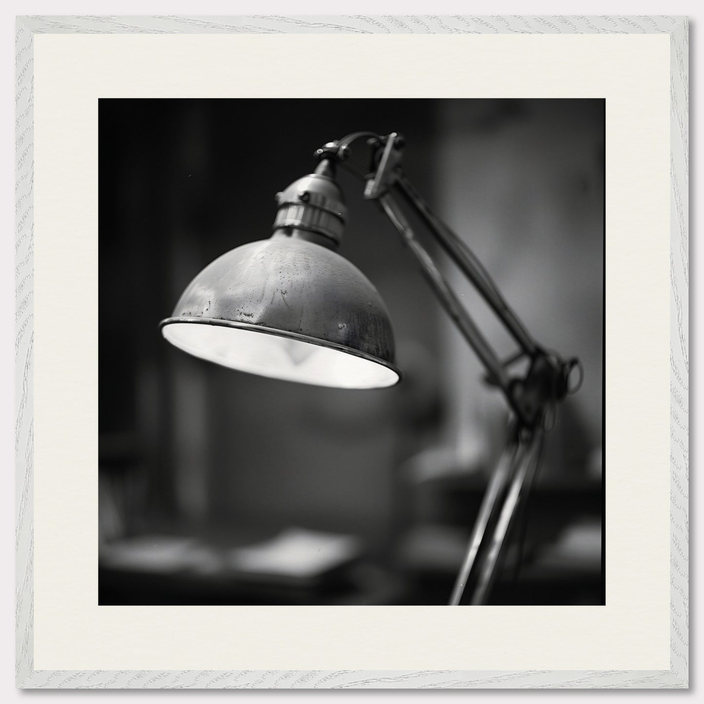 This illustration shows a black and white image of a vintage desk lamp with a metal shade.