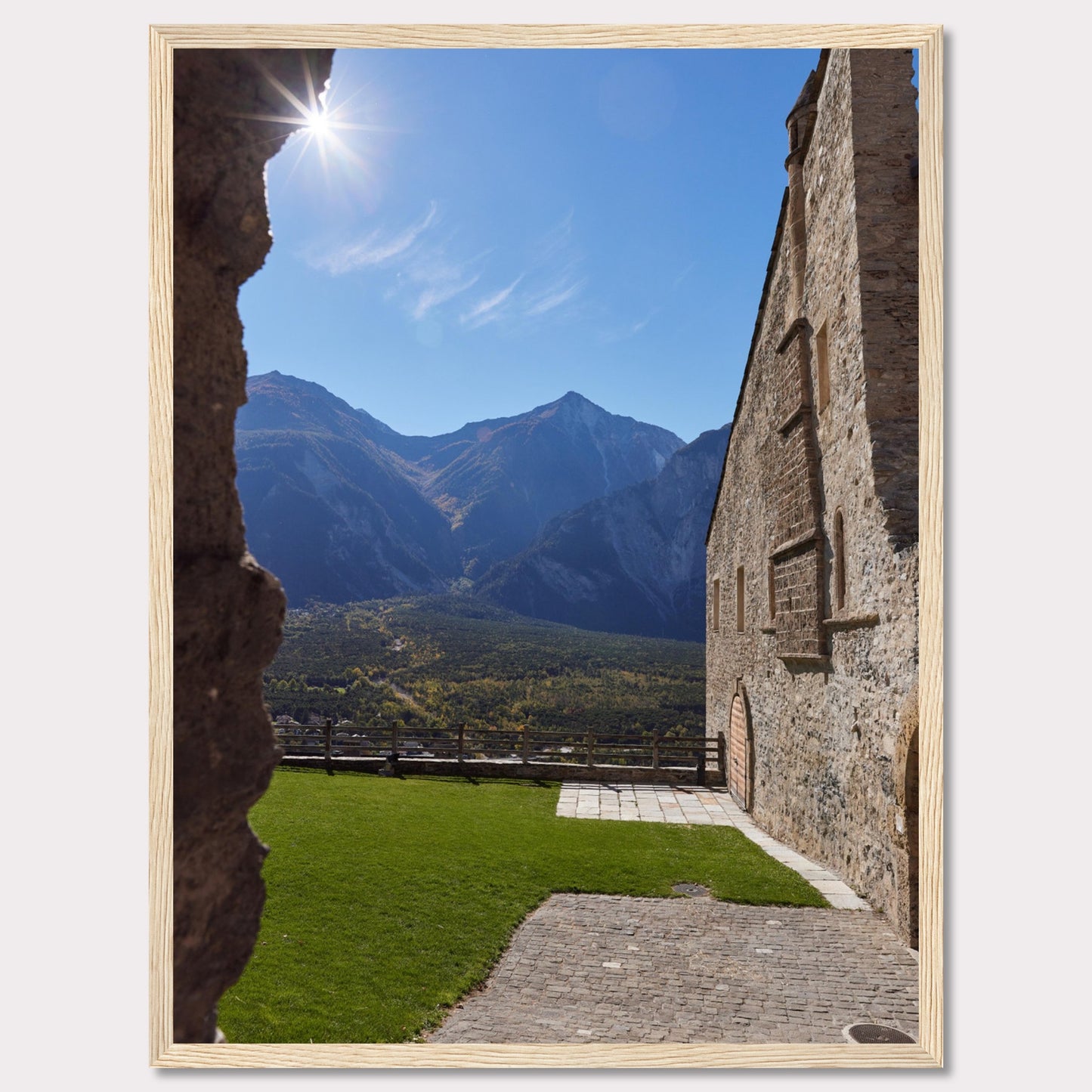 This captivating image showcases a stunning view of a mountainous landscape framed by the rustic stone walls of an ancient structure. The bright sun shines above, casting a warm glow over the scene.