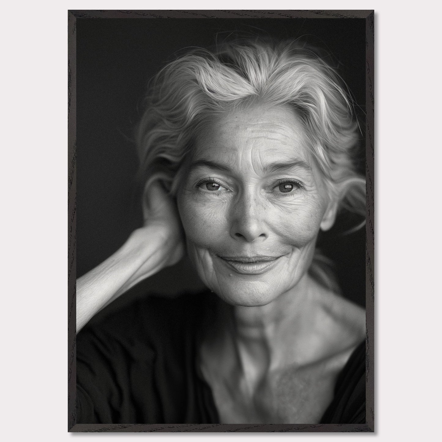 This black and white portrait captures the serene expression of an elderly woman. Her gentle smile and relaxed pose exude wisdom and tranquility, while the fine lines on her face tell a story of a life well-lived.