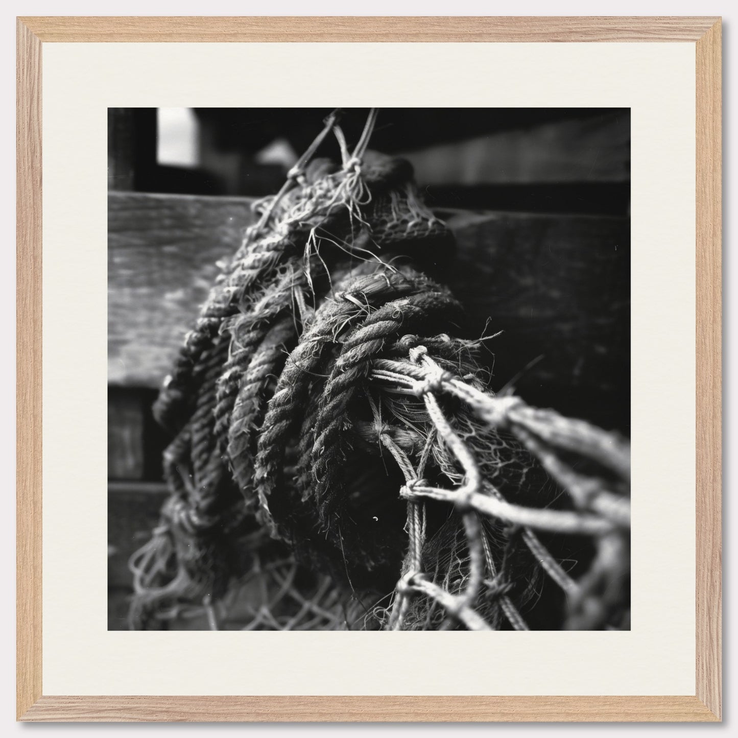 This is a black and white illustration of coiled ropes and fishing nets. The image captures the textures and details of the ropes and nets, emphasizing their rough and worn appearance.