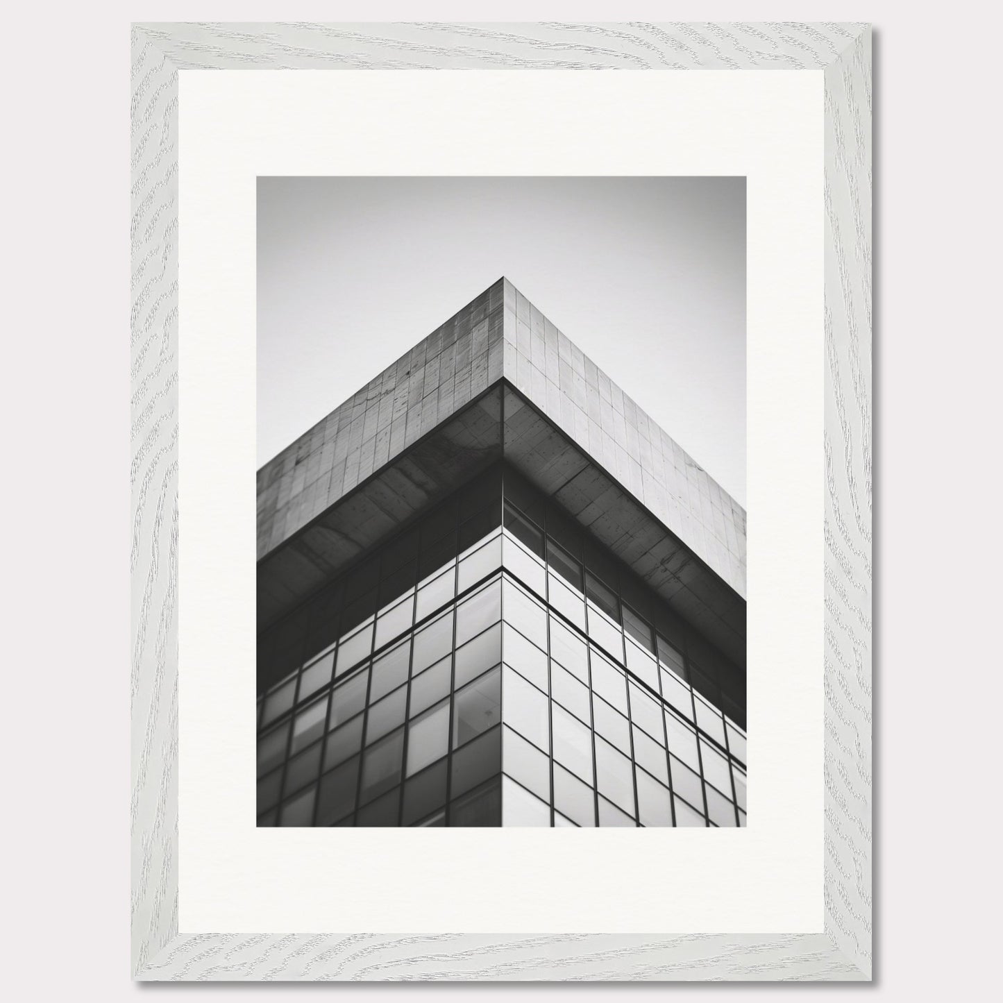 This striking black and white photograph captures the sharp, geometric lines of a modern architectural structure. The image focuses on the corner of a building, emphasizing its sleek glass windows and concrete elements.