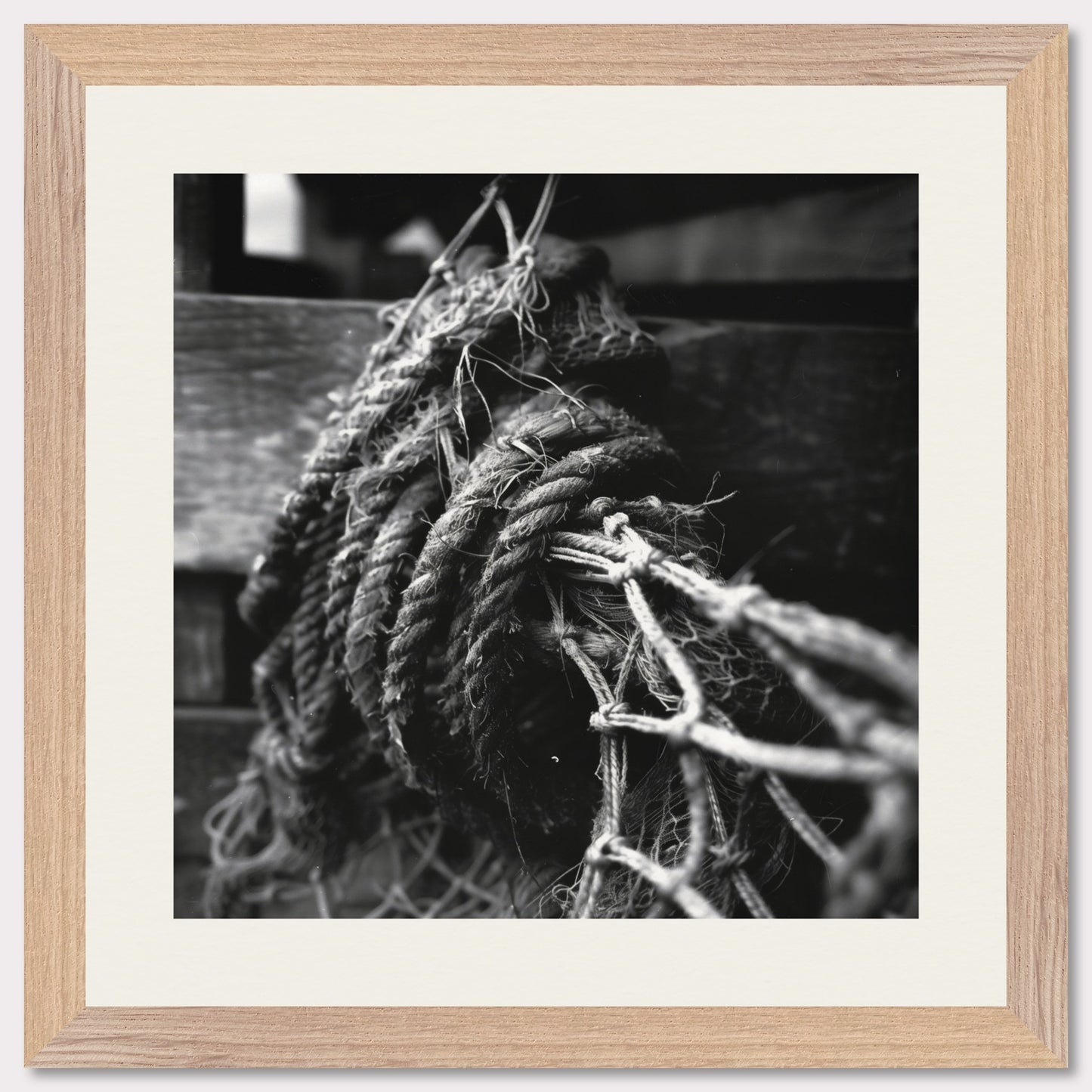 This is a black and white illustration of coiled ropes and fishing nets. The image captures the textures and details of the ropes and nets, emphasizing their rough and worn appearance.