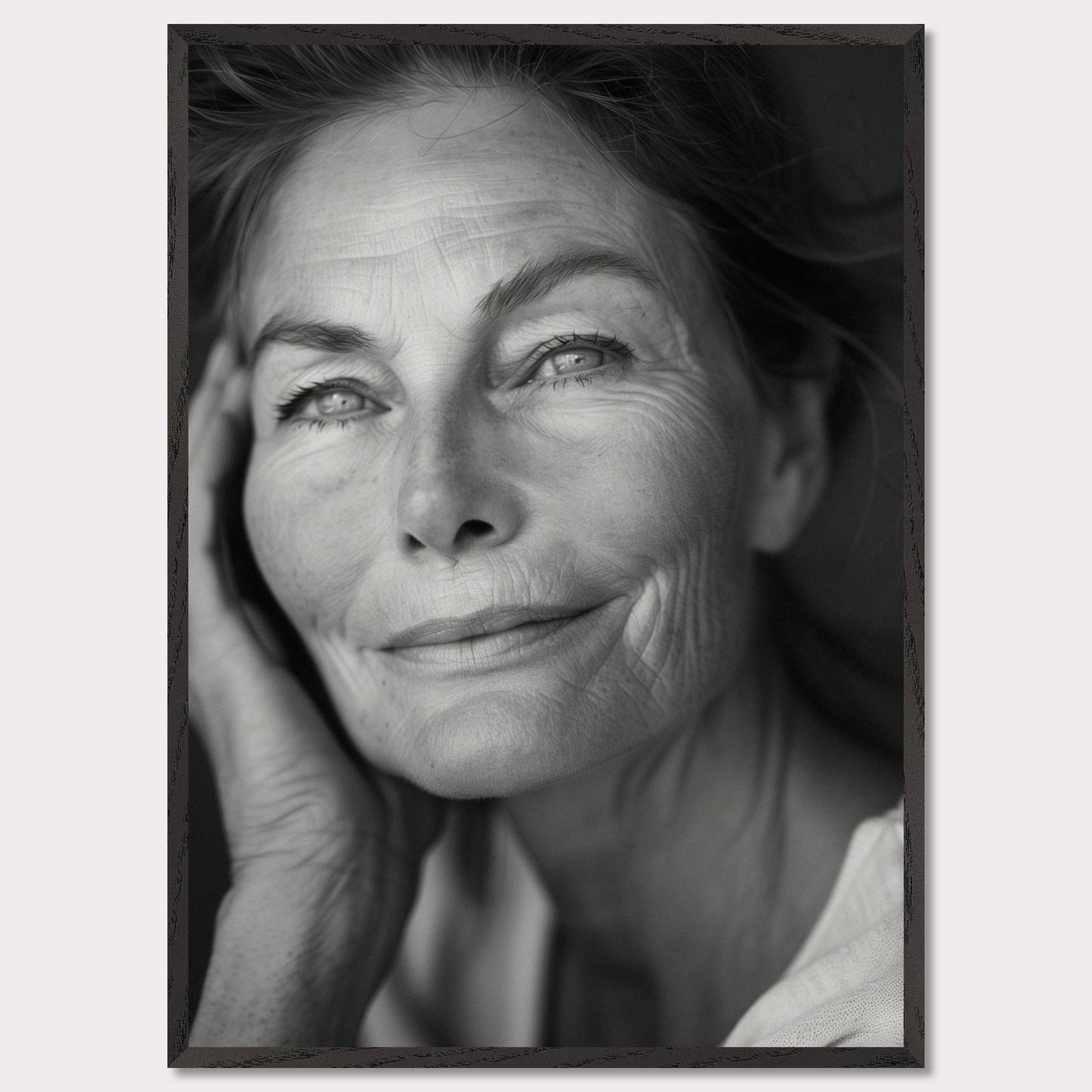 This captivating black-and-white portrait captures the serene and wise expression of an elderly woman. Her gentle smile and thoughtful gaze evoke a sense of peace and contentment. The fine lines on her face tell a story of a life well-lived, filled with experiences and wisdom.