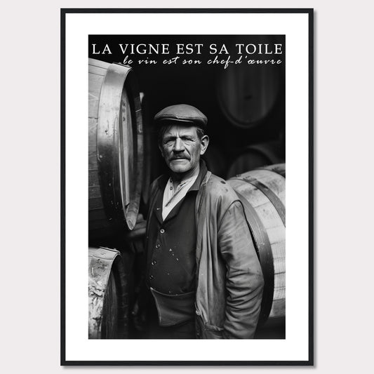 This striking black-and-white photograph captures a seasoned winemaker standing proudly among wine barrels. The text above reads, "La vigne est sa toile, le vin est son chef-d'œuvre," which translates to "The vineyard is his canvas, the wine is his masterpiece." The image exudes a sense of dedication and craftsmanship.