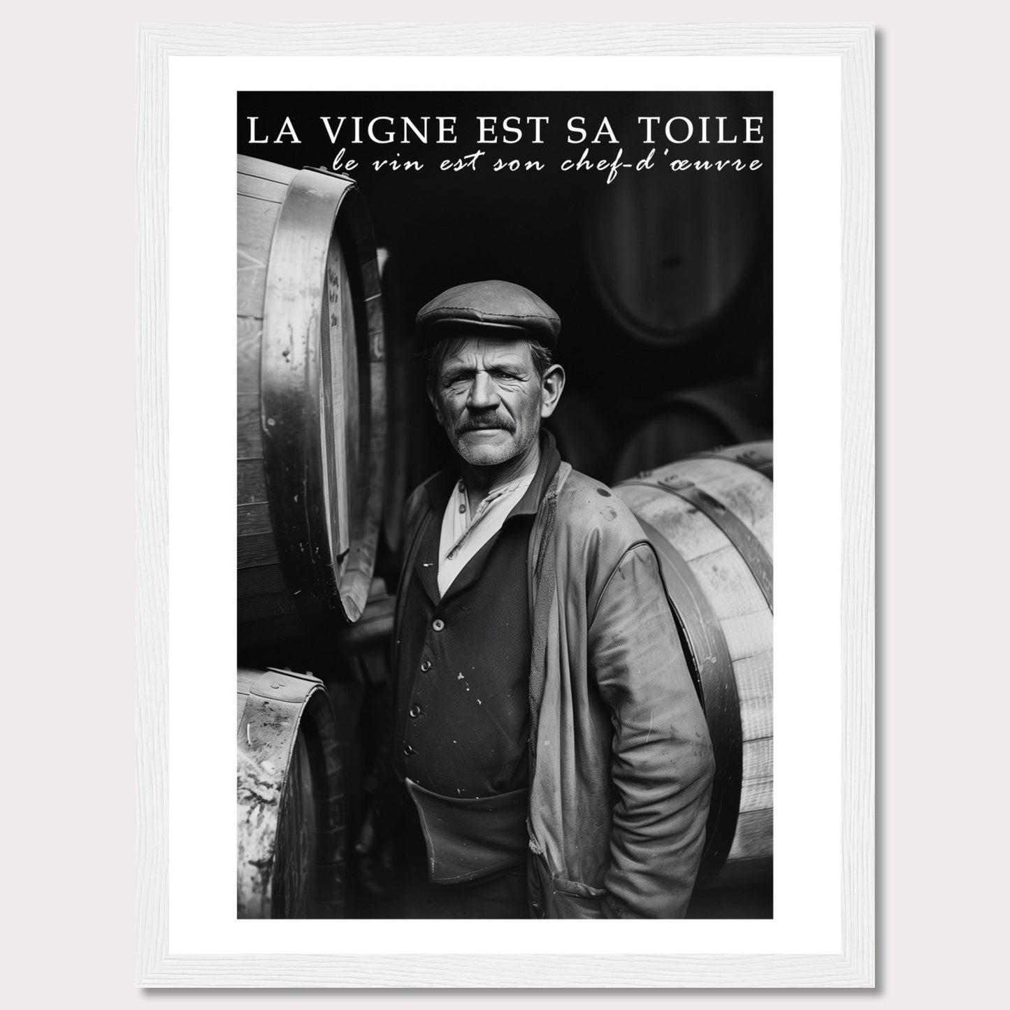 This striking black-and-white photograph captures a seasoned winemaker standing proudly among wine barrels. The text above reads, "La vigne est sa toile, le vin est son chef-d'œuvre," which translates to "The vineyard is his canvas, the wine is his masterpiece." The image exudes a sense of dedication and craftsmanship.