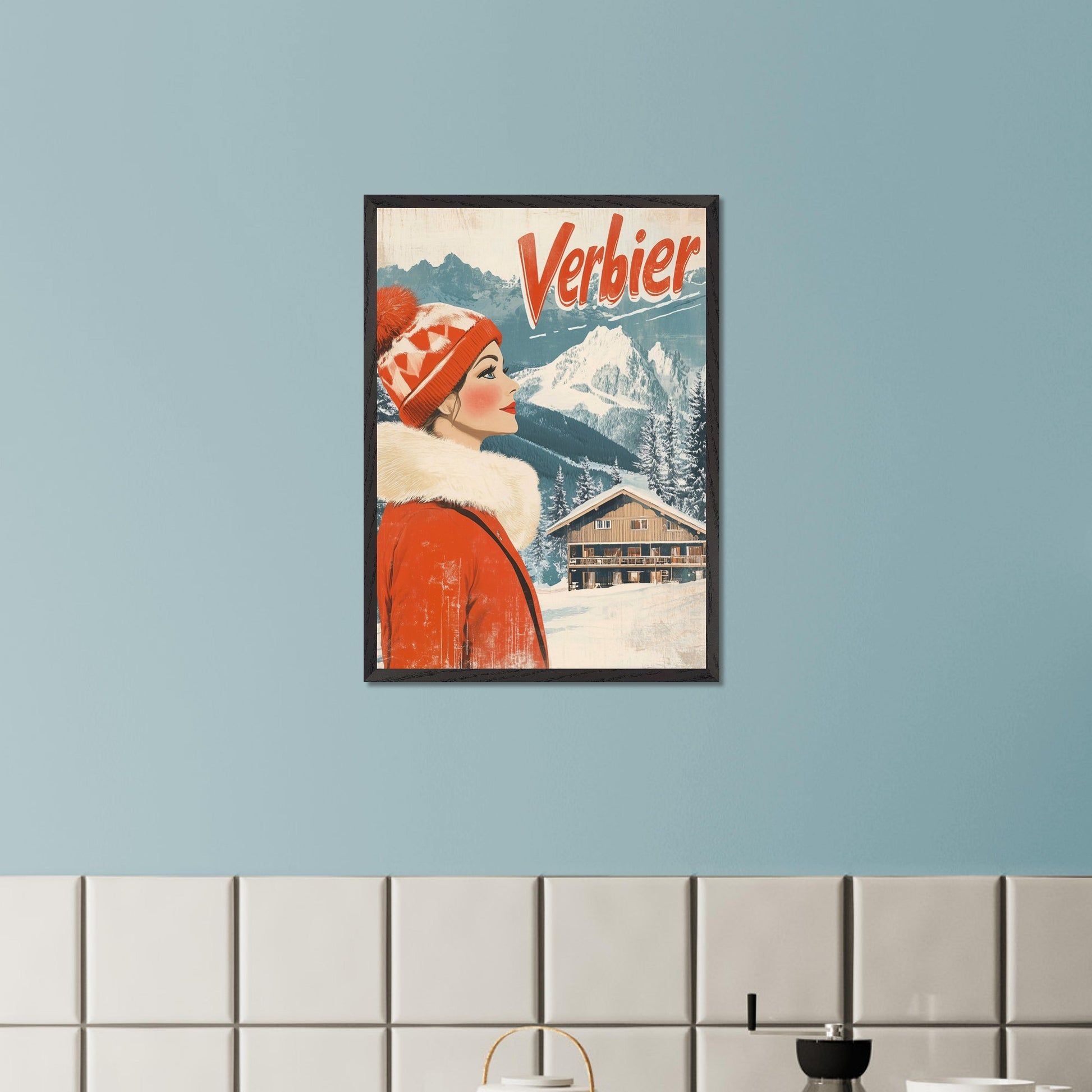 This elegant retro-style poster features a woman in a stylish red winter coat and pom-pom hat, looking towards the majestic Verbier mountains. The soft pastel tones and crisp white snow provide a serene backdrop, while the vintage design and typography evoke a sense of sophistication and timeless charm. The poster conveys the allure of Verbier as both an adventure and a refined escape into nature’s beauty.