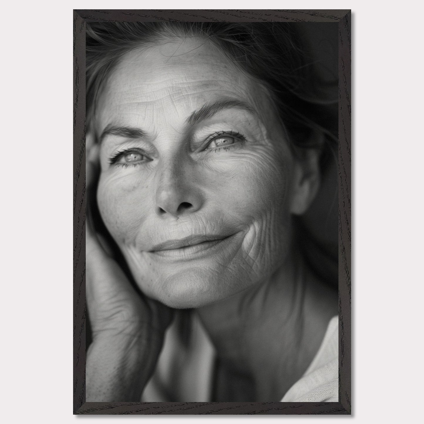 This captivating black-and-white portrait captures the serene and wise expression of an elderly woman. Her gentle smile and thoughtful gaze evoke a sense of peace and contentment. The fine lines on her face tell a story of a life well-lived, filled with experiences and wisdom.